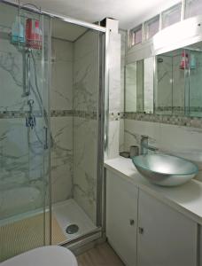 a bathroom with a sink and a glass shower at Vittoria in Lerici