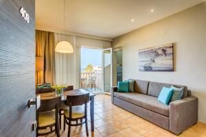 a living room with a couch and a table at Corinna Mare in Kalamaki