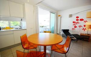 a kitchen and dining room with a wooden table and chairs at Modern Golden Apartment in Cabanas de Tavira +9 photos