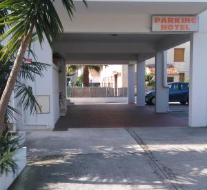 a parking lot of a hotel with a car parked at Hôtel Restaurant Brasilia in Cagnes-sur-Mer