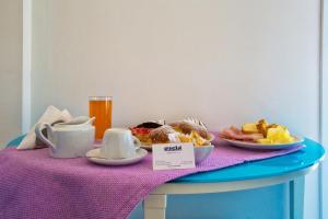 a table with a tray of breakfast food on it at Hotel O'scià in Lampedusa