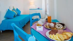 a blue table with two plates of food on it at Hotel O'scià in Lampedusa