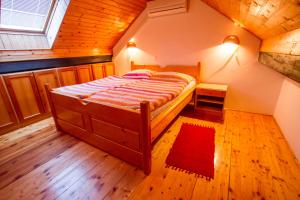a bedroom with a large bed in a attic at Tourist Farm Pri Martinovih in Krška Vas