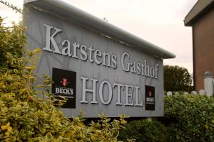 un panneau indiquant un hôtel situé sur le côté d'un bâtiment dans l'établissement Karstens Gasthof, à Nordhastedt