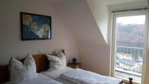 a bedroom with two beds and a large window at Rursee-Panorama in Simmerath