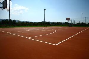 an empty basketball court with a basketball hoop at Campastrello Sport Hotel Residence in Castagneto Carducci