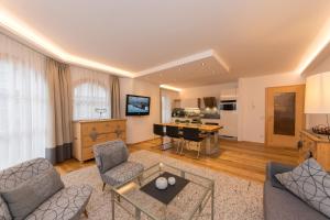 a living room with a couch and a table at Appartements-Pension Renberg in Maria Alm am Steinernen Meer