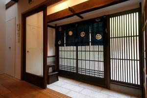 an entrance to a room with a door with a window at HANARé Gion in Kyoto