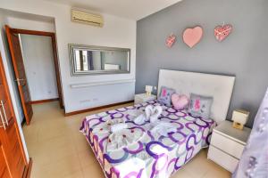 a bedroom with a bed with hearts on the wall at Casa Zen in Puerto Calero +37 photos