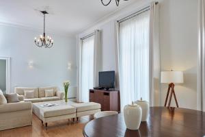 a living room with a couch and a table at Poseidonion Grand Hotel in Spetses