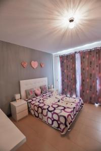 a bedroom with a bed with hearts on the wall at Casa Zen in Puerto Calero