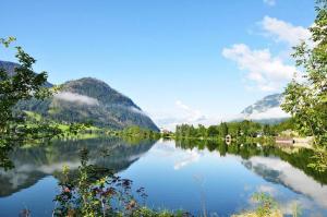 widok na jezioro z górami w tle w obiekcie Greenheart Aussee w mieście Obersdorf