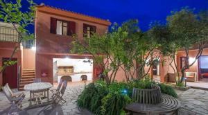 a patio with a table and chairs and a fireplace at The Varos Residences Hotel in Város
