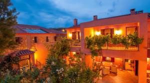 an apartment building with a courtyard at night at The Varos Residences Hotel in Város