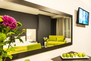 a living room filled with furniture and a tv at Earth & People Hotel & SPA in Sofia