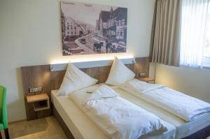 Ein Bett oder Betten in einem Zimmer der Unterkunft Zeitlers Hotel & Apartments