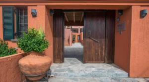 a large vase sitting in front of a building with a door at The Varos Residences Hotel in Város