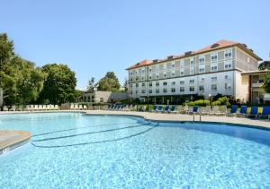 a large swimming pool in front of a hotel at Fort William Henry Hotel in Lake George