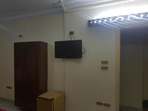 a room with a tv on the corner of a wall at Arabian Nights Hostel in Cairo