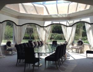 a dining room with a glass table and chairs at Mill Creek Gardens in Winamac