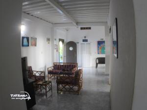 a room with chairs and a table and a piano at Tayrona Dive Center in Taganga