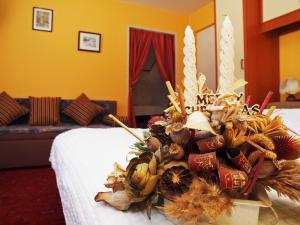 a flower arrangement on a bed in a hotel room at Apartments Gale in Delnice