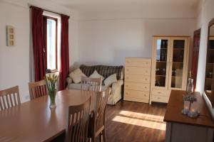 a kitchen and living room with a table and a couch at Wyndcliffe in Grange Over Sands