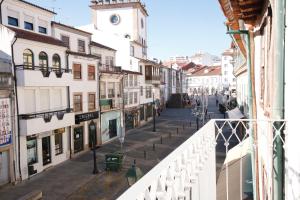 a view of a street from the balcony of a building at Baixa Apartamento in Bragança