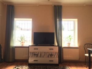 a living room with a tv and two windows at Апартаменты in Izmail