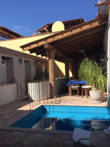 a house with a swimming pool and a patio at Suites colibri in San Miguel de Allende