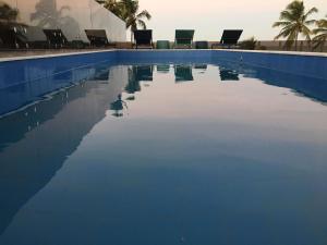 a swimming pool with a duck in the water at Hotel do Mar Cabo Branco in João Pessoa