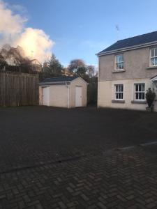 a house with a fence and a brick driveway at 1 Laurel Court in Ulverston