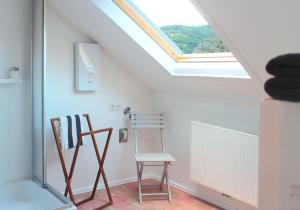a attic room with two chairs and a skylight at Loreley 110 in Sankt Goar
