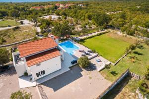 an aerial view of a house with a swimming pool at Villa Mery in Šestanovac