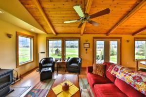 a living room with a red couch and a ceiling fan at Nakiska Ranch in Clearwater