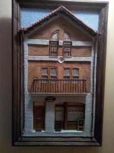 a model of a building with a balcony at Hostal Catalina de Austria in Torquemada