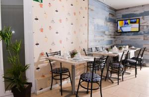 a dining room with tables and chairs and a wall at Hotel Plaza Cascavel in Cascavel