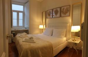 リスボンにあるCentral Lisbon Classic Apartmentのベッドルーム1室(ベッド1台、タオル2枚付)