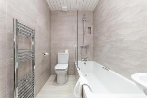 a bathroom with a toilet and a shower and a sink at Osborne Hotel in Newcastle upon Tyne