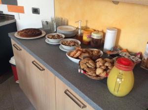 a kitchen counter with plates of food on it at B&B La Marmotta in Malè +12 photos
