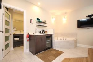 a large bathroom with a sink and a tub at Kemptville Suites in Kemptville