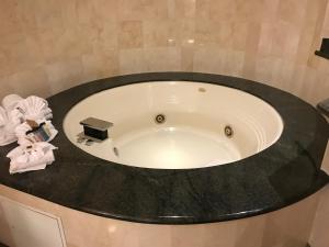 a bath tub in a bathroom with a sink at Hollywood Hotel in Los Angeles
