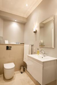 a bathroom with a sink and a toilet and a mirror at B&B Downham Hall in Wickford +32 photos