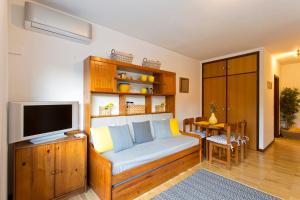 a living room with a couch and a television at JS Apartment in Coimbra