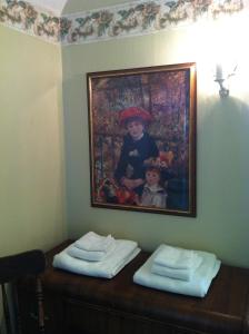a painting of a child on a wall with two towels at Sir Edgar House B&B in Dauphin