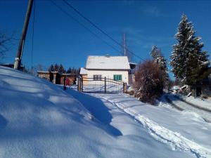 帕莱Kuća Aska的房屋前有雪覆盖的道路