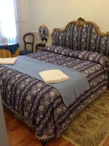 a bedroom with a bed with a blue comforter at Casa Alla Fenice in Venice