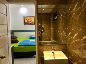 A bed or beds in a room at Ahlen Pangandaran