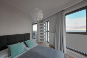 Posteľ alebo postele v izbe v ubytovaní Apartament Horyzont Amber