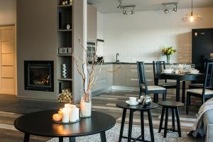 a living room with two tables and a fireplace at Estate Holiday home in Kuldīga